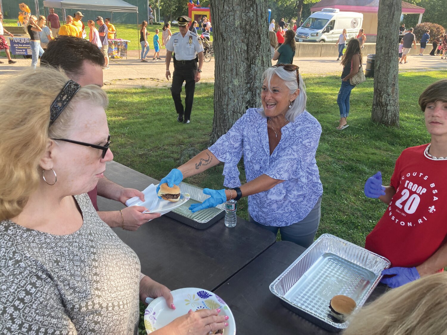 BURGER BUDDY: Councilwoman Lauren Garzone raced to fill attendees' plates with burgers from the grill.